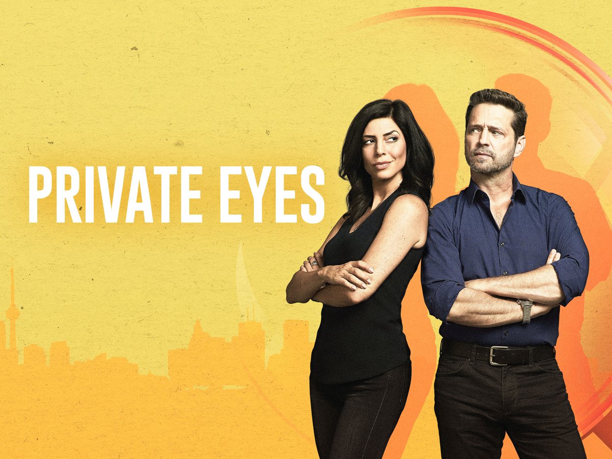 Cindy Sampson and Jason Priestley, arms crossed, beside the words "Private Eyes" over a yellow Toronto skyline.